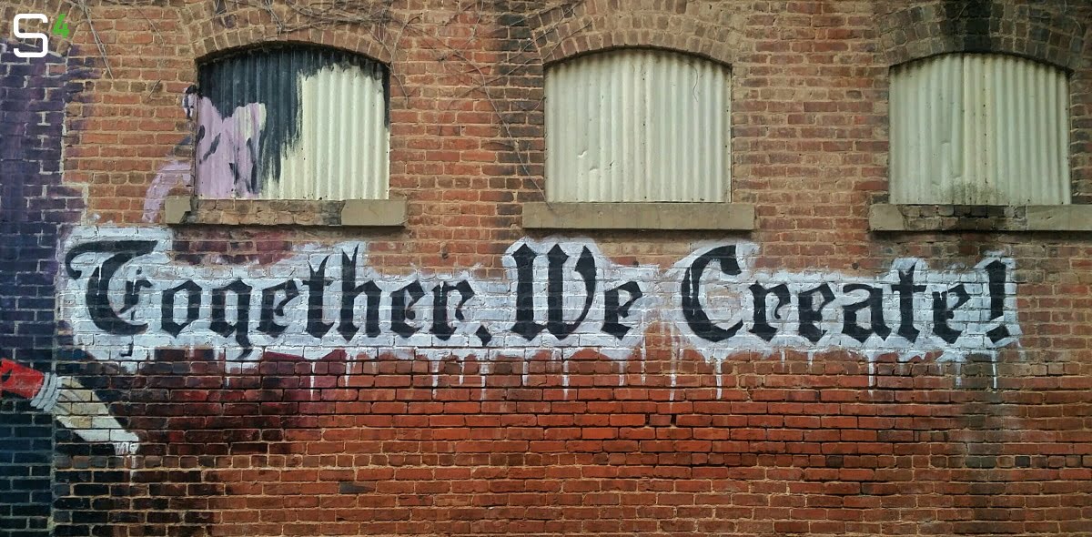 Graffiti reading 'Together We Create'